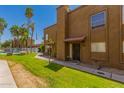 Attractive townhouse exterior features a red tile roof, secure front door, and a well-kept green lawn at 16225 N 30Th St # 11, Phoenix, AZ 85032