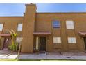 Welcoming townhouse exterior boasts a red-tiled roof, secure front door, and well-maintained lawn at 16225 N 30Th St # 11, Phoenix, AZ 85032