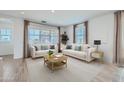Bright living room with neutral decor, stylish furniture, and natural light from the large windows at 16381 W Weeping Willow Rd, Surprise, AZ 85387