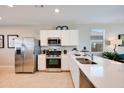 Bright kitchen featuring stainless steel appliances, quartz countertops, and ample cabinet space at 16754 W Alameda Rd, Surprise, AZ 85387