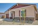 Attractive single-level house with a well-manicured front yard and inviting entry at 16781 W Bronco Trl, Surprise, AZ 85387