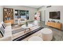 Bright living room with modern furniture, stylish rug, and view of the front yard at 1913 N Verano Way, Chandler, AZ 85224