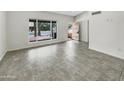 Bright and airy living room featuring modern tile flooring and a view to the entry at 1913 N Verano Way, Chandler, AZ 85224