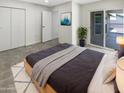 Cozy main bedroom with a comfortable bed, stylish decor, and access to an outdoor patio at 1913 N Verano Way, Chandler, AZ 85224
