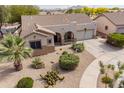 Beautiful single-story home showcasing desert landscaping, a covered front porch, and a two-car garage at 19537 E Thornton Rd, Queen Creek, AZ 85142