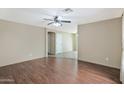 Spacious living room with dark wood floors, neutral walls, and a ceiling fan at 2112 E Donald Dr, Phoenix, AZ 85024