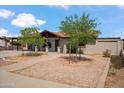 Traditional single-story home featuring desert landscaping, brick accents, and a covered carport at 2217 N 51St Ln, Phoenix, AZ 85035