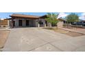 Single-story home boasting a covered carport, desert landscaping, and brick pathway leading to the front door at 2217 N 51St Ln, Phoenix, AZ 85035