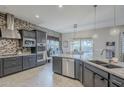Beautiful kitchen with granite countertops, modern backsplash and a stainless steel dishwasher at 2525 W Balao Dr, Phoenix, AZ 85085