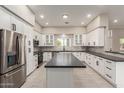 Bright kitchen features white cabinetry, stainless steel appliances, and a large island at 25450 W Pueblo Ave, Buckeye, AZ 85326