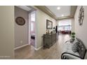 Inviting foyer with wood-look tile floors, decorative accents, and an open view to the living areas at 3359 E Penedes Dr, Gilbert, AZ 85298