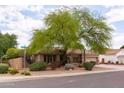Charming home featuring lush landscaping and a large shade tree, complemented by a well-manicured front yard at 345 S Buena Vista Ave, Gilbert, AZ 85296