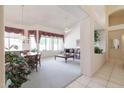 Spacious living room with light-colored walls, a ceiling fan, large windows, and a combined dining area at 345 S Buena Vista Ave, Gilbert, AZ 85296