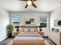 Comfortable bedroom with natural light, ceiling fan, and neutral decor for a peaceful retreat at 35337 W San Alvarez Ave, Maricopa, AZ 85138