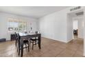 Sunlit dining area with tiled floors and large windows, perfect for entertaining or enjoying Gathering dinners at 3709 W Grovers Ave, Glendale, AZ 85308