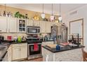 Well-lit kitchen featuring modern stainless steel appliances, tile backsplash, and custom countertops at 44810 W Horse Mesa Rd, Maricopa, AZ 85139