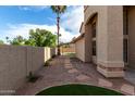 Private backyard showcasing desert landscaping, stone pavers, and a covered patio at 4653 W Dublin St, Chandler, AZ 85226