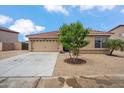 Front exterior view of a home featuring low maintenance landscaping, neutral color palette, and attached two car garage at 4728 N 92Nd Ave, Phoenix, AZ 85037