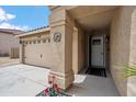 Exterior view featuring the front door with sidelight, landscaping, and two car garage at 4728 N 92Nd Ave, Phoenix, AZ 85037