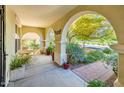 Covered front porch, featuring arched columns, has ample seating for relaxing outdoors at 4836 S Covalent Ln, Mesa, AZ 85212