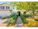Inviting home with mature landscaping and walkway leading to the charming covered front porch at 4836 S Covalent Ln, Mesa, AZ 85212