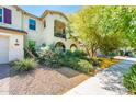 View of home showing well-maintained landscaping including lush plants and walkway to front door at 4836 S Covalent Ln, Mesa, AZ 85212