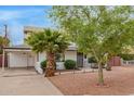 Charming home featuring a well-maintained front yard with desert landscaping and mature trees at 5025 N 20Th Ave, Phoenix, AZ 85015