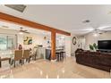 Open-concept living space with tile flooring, wood beams, and ample natural light at 5025 N 20Th Ave, Phoenix, AZ 85015