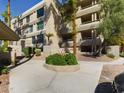 Exterior shot of condo building with landscaping, carport, and multiple levels of balconies at 5124 N 31St Pl # 522, Phoenix, AZ 85016