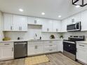 Modern kitchen featuring white cabinets, stainless steel appliances, quartz countertops, and modern fixtures at 5124 N 31St Pl # 522, Phoenix, AZ 85016