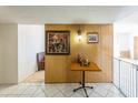 Entryway featuring wood paneling, tile flooring, and decorative light fixture at 6445 W Windsor Blvd, Glendale, AZ 85301