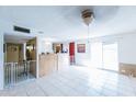 A spacious room with tile floors, white walls, and large windows for natural light at 6445 W Windsor Blvd, Glendale, AZ 85301