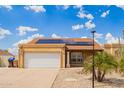 Inviting single-story home boasts solar panels, a two-car garage, and low-maintenance desert landscaping at 6908 W Sunnyside Dr, Peoria, AZ 85345