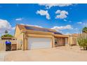 Inviting single-story home boasts solar panels, a two-car garage, and desert landscaping at 6908 W Sunnyside Dr, Peoria, AZ 85345