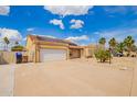 Inviting single-story home featuring solar panels, a two-car garage, and desert landscaping at 6908 W Sunnyside Dr, Peoria, AZ 85345