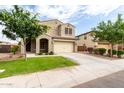 Charming two-story home with a well-manicured lawn and a spacious two-car garage at 7342 S Debra Dr, Gilbert, AZ 85298