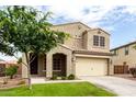 Charming two-story home with a well-manicured lawn and a spacious two-car garage at 7342 S Debra Dr, Gilbert, AZ 85298