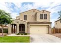 Charming two-story home with a well-manicured lawn and a spacious two-car garage at 7342 S Debra Dr, Gilbert, AZ 85298