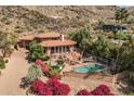 Stunning aerial view of a luxurious home showcasing the beautiful pool, landscaping, and surrounding desert scenery at 8031 N 54Th St, Paradise Valley, AZ 85253