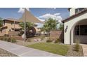 Community playground with climbing structure, benches, and landscaping near a stucco home at 9627 W Cheery Lynn Rd, Phoenix, AZ 85037
