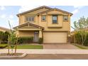 Two-story home features attached two car garage, stucco facade, and manicured front yard at 9911 E Telemetry Dr, Mesa, AZ 85212