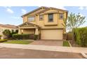 Inviting two-story home with a two-car garage, neat landscaping, and a paved driveway at 9911 E Telemetry Dr, Mesa, AZ 85212