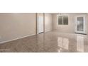 Bright, open living room with tile floors, neutral walls, and ample natural light at 10 N 87Th Dr, Tolleson, AZ 85353