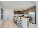 Modern kitchen with stainless steel appliances, island with seating, pendant lighting, and white countertops at 10049 E Ulysses Ave, Mesa, AZ 85212