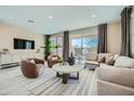 Stylish living room with plush seating, neutral decor, contemporary accents, lots of natural light, and outdoor access at 10049 E Ulysses Ave, Mesa, AZ 85212