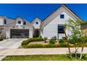 Beautifully landscaped new construction home features a two-car garage and white exterior at 10156 E Talon Ave, Mesa, AZ 85212