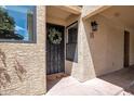 Close-up of the front door with a decorative wreath and a 'hello' doormat at 10235 N 31St St # 15, Phoenix, AZ 85028