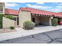 Attractive townhome exterior with a red tile roof and a covered parking area at 10235 N 31St St # 15, Phoenix, AZ 85028