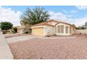 Street view of a charming single-story home with a two-car garage and desert landscaping at 1130 W Kingbird Dr, Chandler, AZ 85286