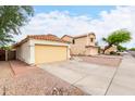 Low angle view of a single-story home with a two-car garage and mature trees at 1130 W Kingbird Dr, Chandler, AZ 85286